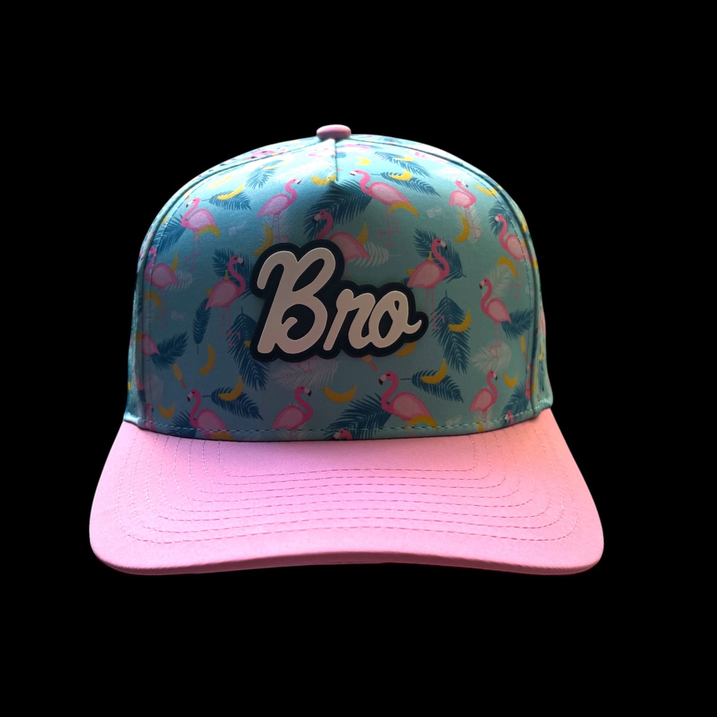 GolferBro snapback cap with a turquoise, flamingo, and banana print. Features a pink bill and "Bro" logo.