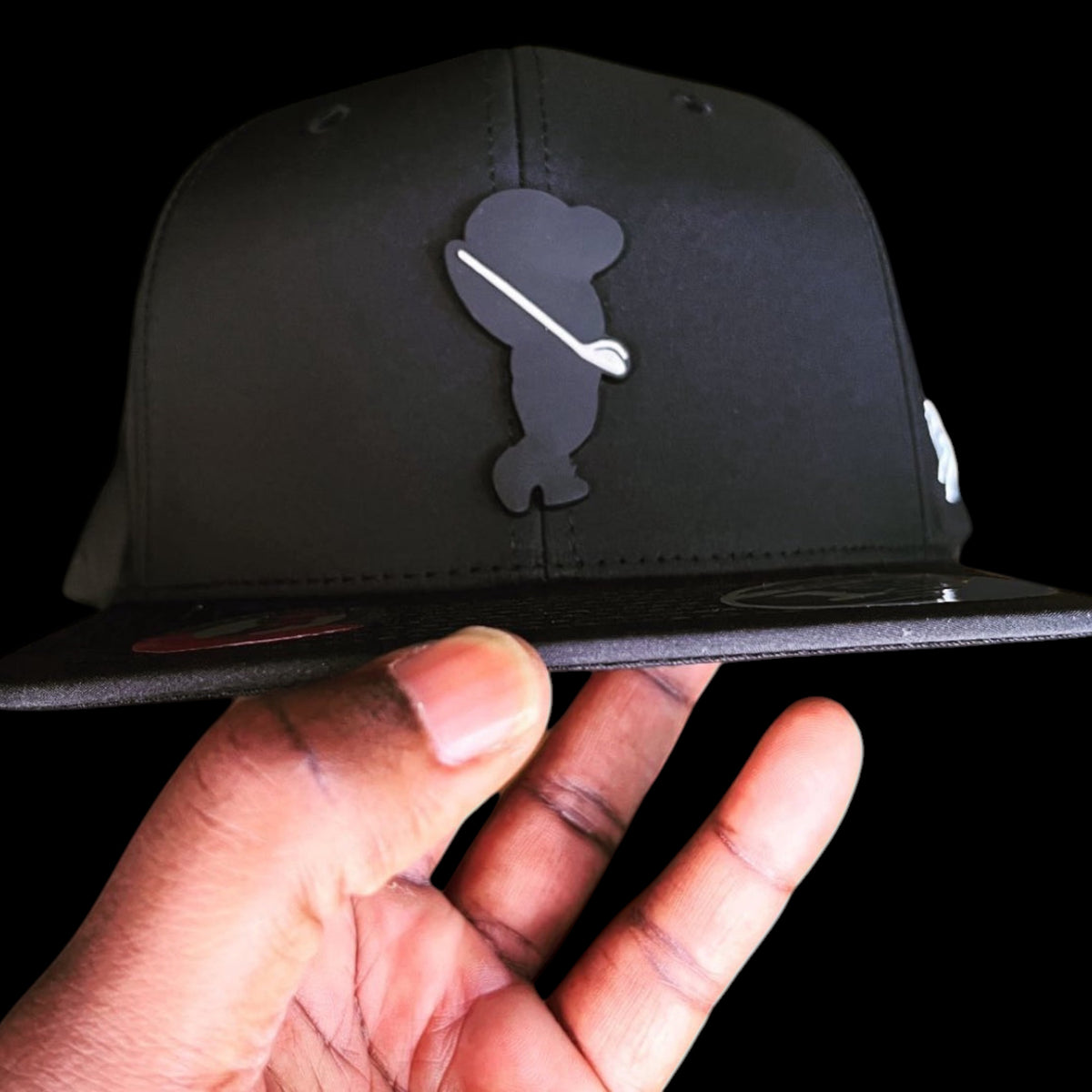 GolferBro black performance cap with a golf-themed patch, featuring lightweight, water-resistant polyester fabric.