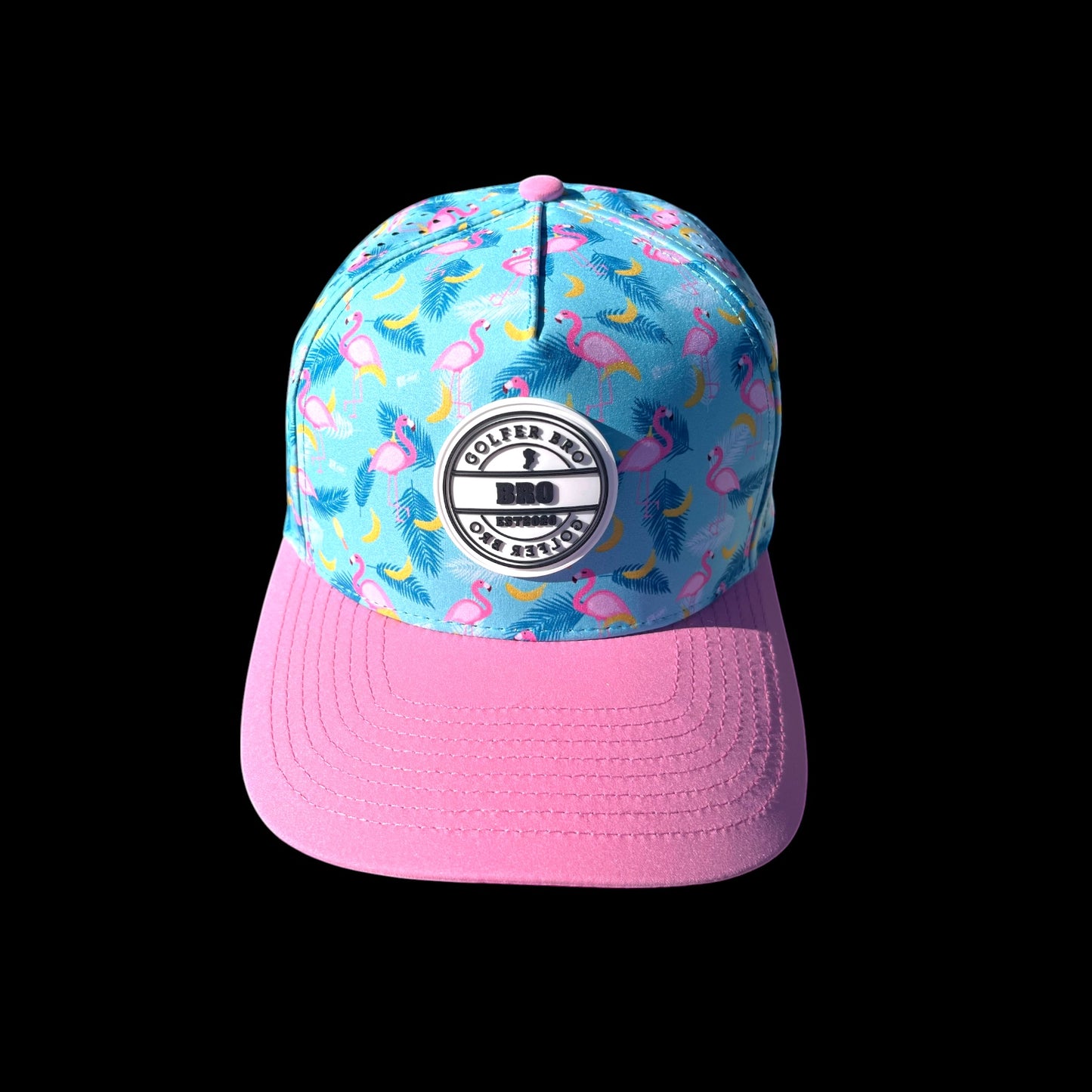 Golfer Bro blue cap with pink brim, featuring a flamingo and banana print. Made of polyester and spandex with a snapback closure.