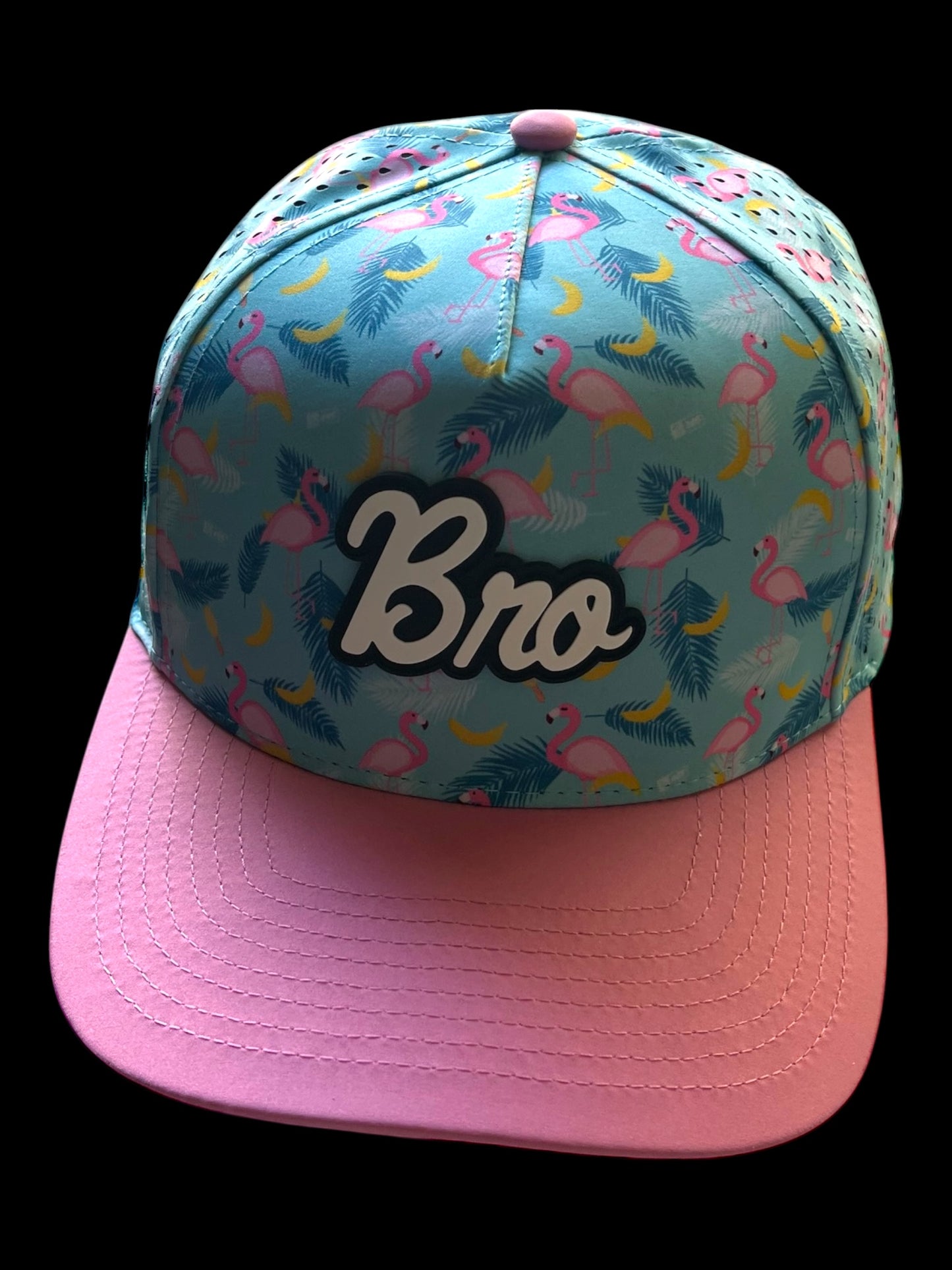 GolferBro snapback cap with a flamingo and banana print on a blue background, featuring a pink bill and "Bro" logo.